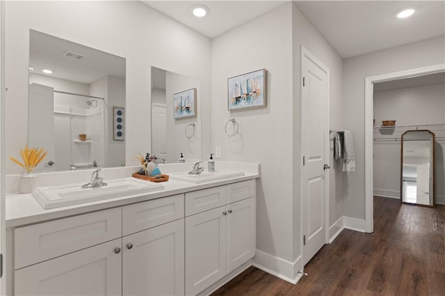 bathroom with a shower, vanity, and hardwood / wood-style flooring