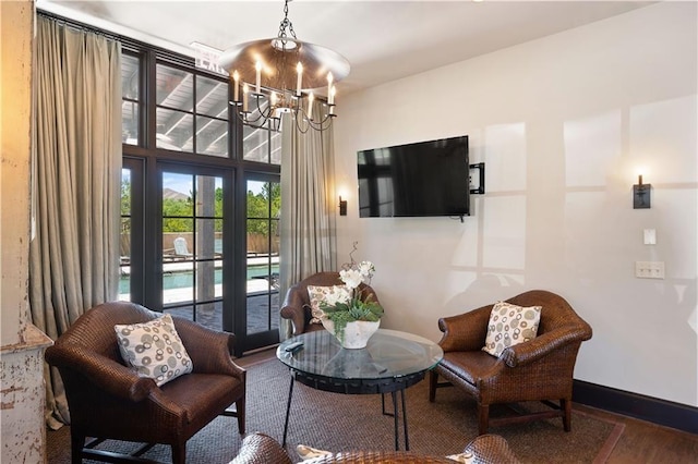 living room with wood-type flooring and a notable chandelier