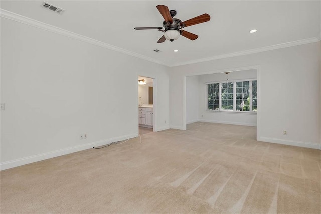 empty room featuring visible vents, ornamental molding, ceiling fan, and light carpet