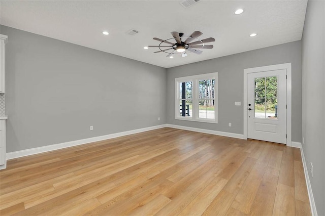 interior space with light wood-type flooring and ceiling fan