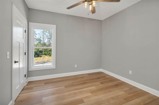 empty room featuring ceiling fan, light hardwood / wood-style floors, and a textured ceiling