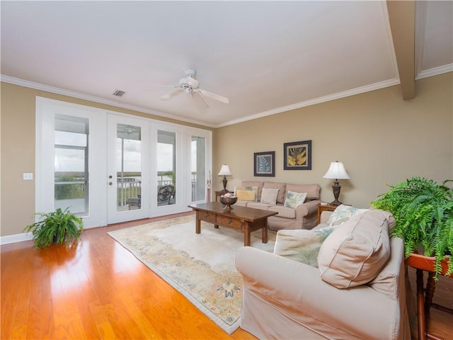 1106 Plantation Point Dr, Saint Simons Island, GA 31522 - living room with a ceiling fan, wood finished floors, healthy amount of natural light, ornamental molding, and baseboards