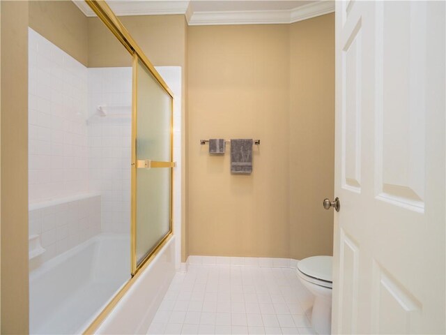1106 Plantation Point Dr, Saint Simons Island, GA 31522 - bathroom with tile patterned flooring, crown molding, toilet, baseboards, and shower / bath combination with glass door