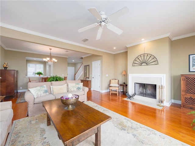 1106 Plantation Point Dr, Saint Simons Island, GA 31522 - living area with wood finished floors, stairway, baseboards, a fireplace, and a chandelier
