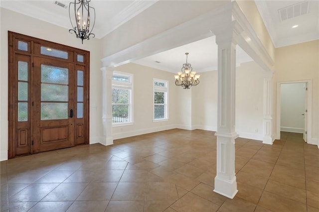 tiled entrance foyer with decorative columns, ornamental molding, and an inviting chandelier