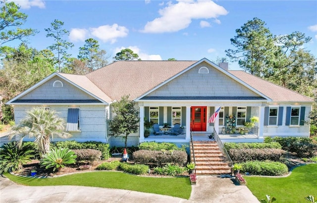 view of front of house featuring a front yard and covered porch