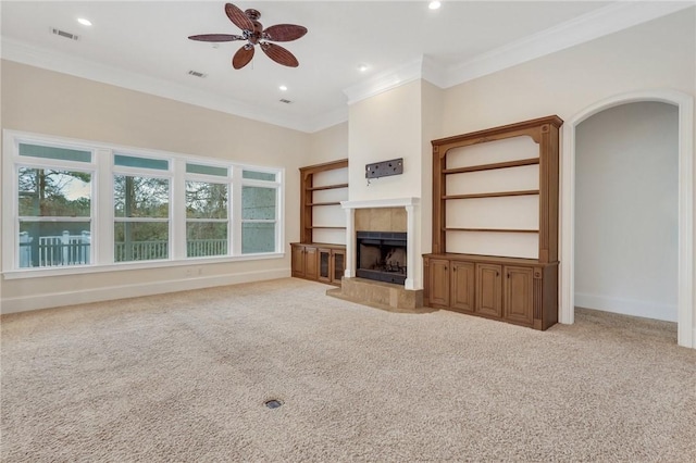 unfurnished living room featuring ornamental molding, plenty of natural light, and light carpet