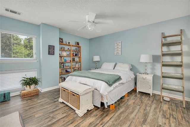 1000 Mallery Street Ext Unit G62, Saint Simons Island, GA 31522 - bedroom with wood finished floors, a textured ceiling, baseboards, and ceiling fan