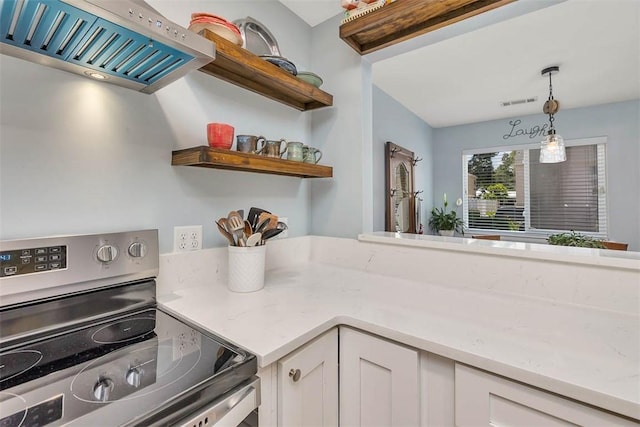 1000 Mallery Street Ext Unit G62, Saint Simons Island, GA 31522 - kitchen with stainless steel electric range oven, ventilation hood, white cabinets, decorative light fixtures, and open shelves