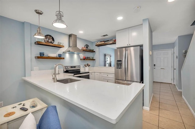 1000 Mallery Street Ext Unit G62, Saint Simons Island, GA 31522 - kitchen featuring appliances with stainless steel finishes, open shelves, wall chimney exhaust hood, a sink, and a peninsula