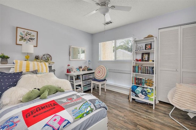 1000 Mallery Street Ext Unit G62, Saint Simons Island, GA 31522 - bedroom featuring wood finished floors, a closet, a textured ceiling, and ceiling fan