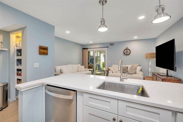 1000 Mallery Street Ext Unit G62, Saint Simons Island, GA 31522 - kitchen with open floor plan, a sink, stainless steel dishwasher, light countertops, and white cabinetry