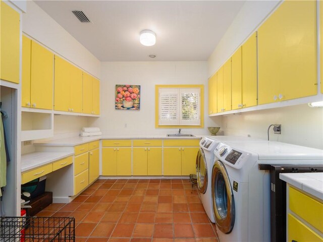 104 Colony Pl, Saint Simons Island, GA 31522 - laundry room featuring separate washer and dryer, cabinet space, tile patterned floors, and a desk