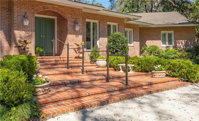doorway to property with brick siding