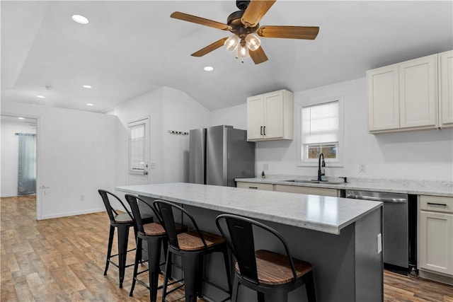 544 Lud Oquinn Rd, Odum, GA 31555 - kitchen with appliances with stainless steel finishes, a sink, a kitchen breakfast bar, a center island, and ceiling fan