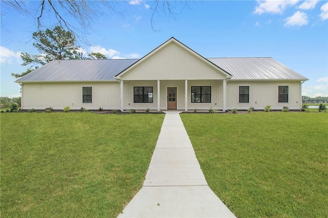 modern farmhouse style home with covered porch and a front yard