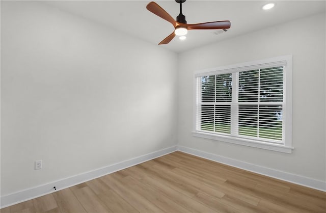 empty room featuring ceiling fan and light hardwood / wood-style floors