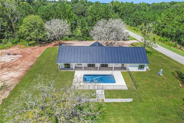 view of swimming pool with a patio area and a yard