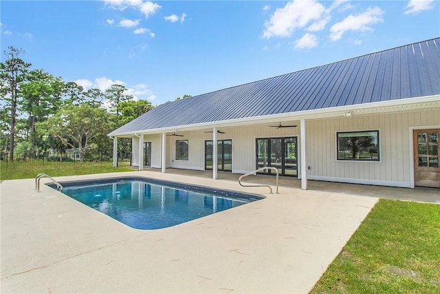 view of swimming pool featuring ceiling fan and a patio