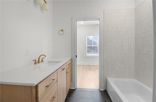 bathroom featuring tile patterned floors, vanity, and tiled shower / bath