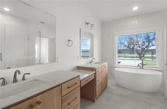 bathroom featuring tile patterned floors, vanity, tile walls, and shower with separate bathtub