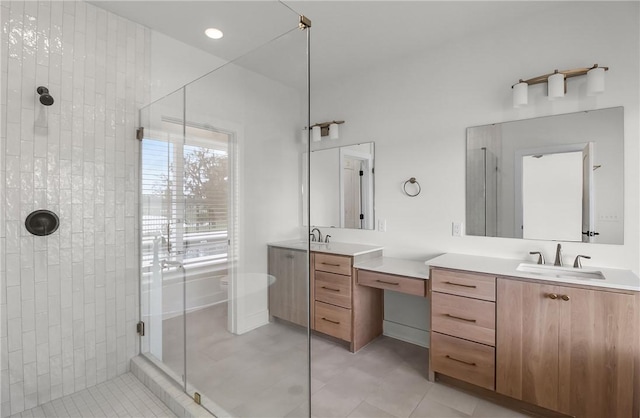 bathroom with tile patterned floors, a shower with door, and vanity