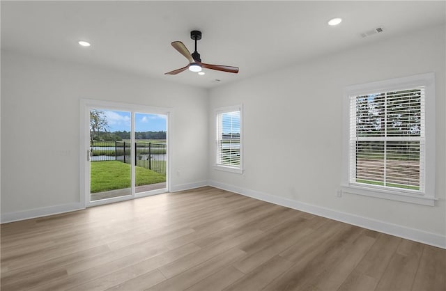 spare room featuring light hardwood / wood-style floors and ceiling fan