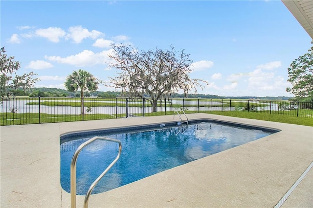 view of pool with a patio area and a water view