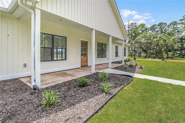 doorway to property with a lawn