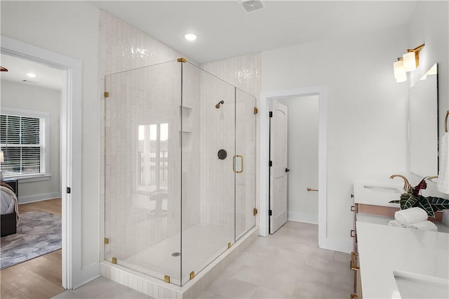 bathroom featuring vanity, hardwood / wood-style flooring, and walk in shower