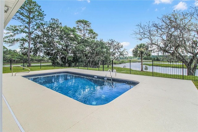 view of pool with a patio area and a water view