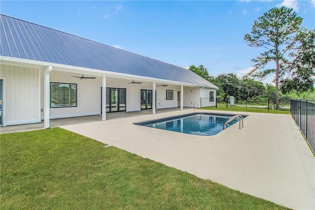 view of pool featuring a patio area, ceiling fan, and a yard