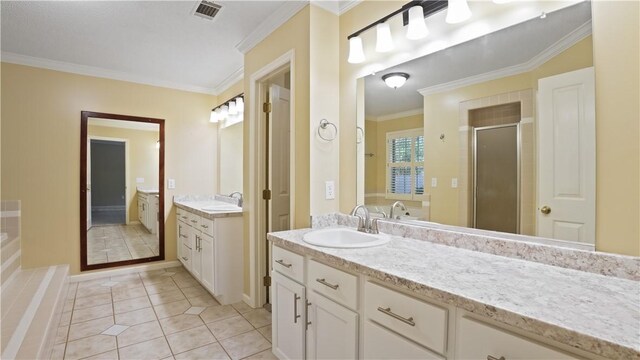 500 Altamaha Rd, Jesup, GA 31545 - full bathroom featuring crown molding, a stall shower, two vanities, a bath, and tile patterned flooring