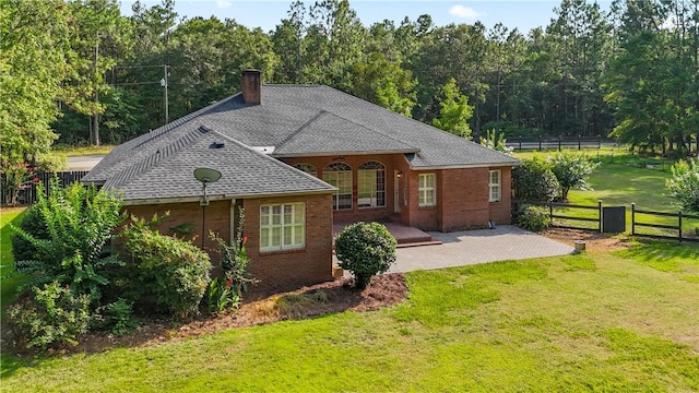500 Altamaha Rd, Jesup, GA 31545 - rear view of house featuring a chimney, a patio area, brick siding, and roof with shingles