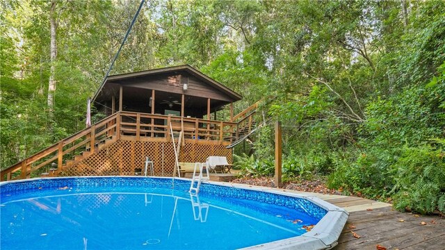 500 Altamaha Rd, Jesup, GA 31545 - outdoor pool featuring stairs, ceiling fan, and a wooden deck