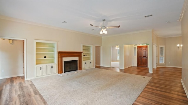 500 Altamaha Rd, Jesup, GA 31545 - unfurnished living room with wood finished floors, ceiling fan, a premium fireplace, built in features, and crown molding