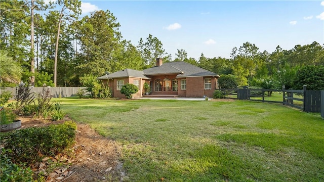 500 Altamaha Rd, Jesup, GA 31545 - rear view of property with a fenced backyard, a chimney, and a patio