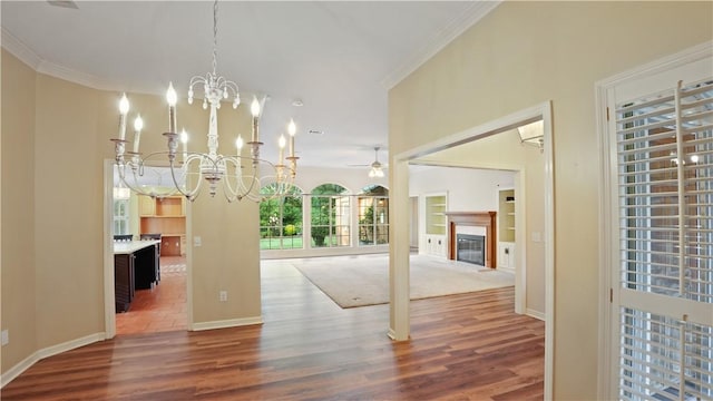500 Altamaha Rd, Jesup, GA 31545 - unfurnished dining area featuring wood finished floors, ceiling fan, a chandelier, crown molding, and a glass covered fireplace