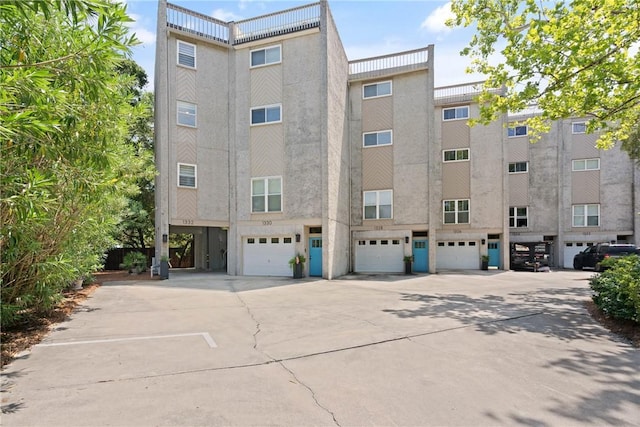 1332 Oak St Unit 9, Saint Simons Island, GA 31522 - view of property featuring an attached garage and driveway