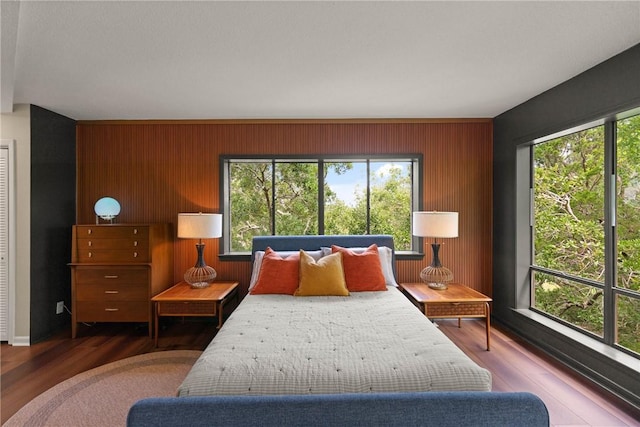 1332 Oak St Unit 9, Saint Simons Island, GA 31522 - bedroom featuring wood finished floors and wood walls