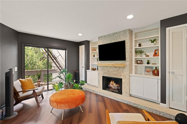 1332 Oak St Unit 9, Saint Simons Island, GA 31522 - living area with a fireplace, wood finished floors, built in features, and recessed lighting