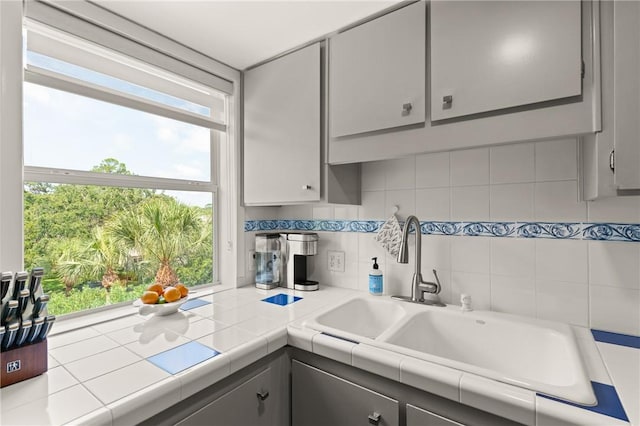 1332 Oak St Unit 9, Saint Simons Island, GA 31522 - kitchen featuring gray cabinetry, plenty of natural light, and backsplash