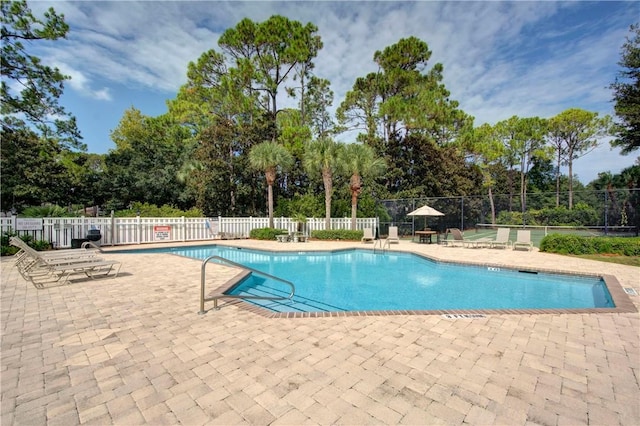 pool featuring a patio area and fence