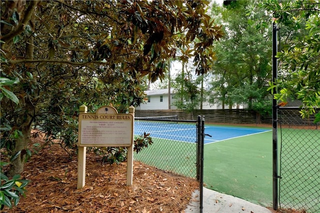 view of sport court featuring fence