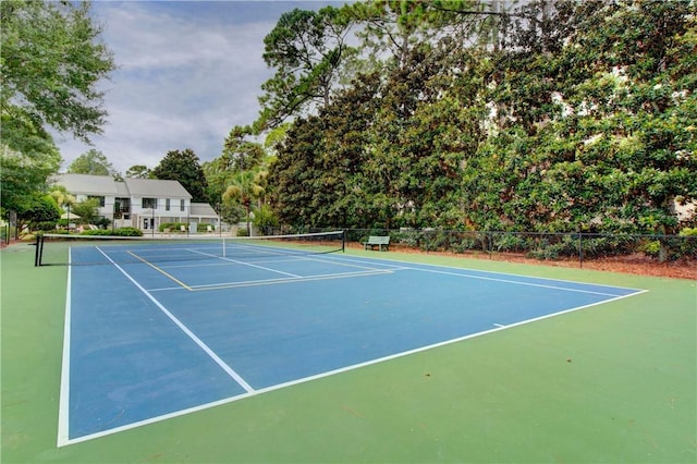 view of tennis court featuring fence