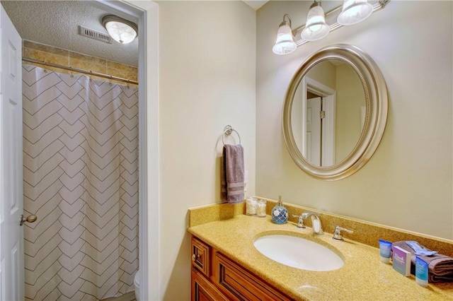 full bathroom with vanity, a shower with shower curtain, and a textured ceiling