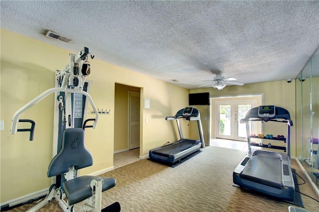 exercise room with baseboards, visible vents, french doors, a textured ceiling, and carpet flooring