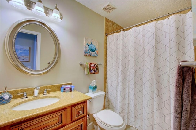 bathroom with visible vents, toilet, vanity, and a shower with curtain