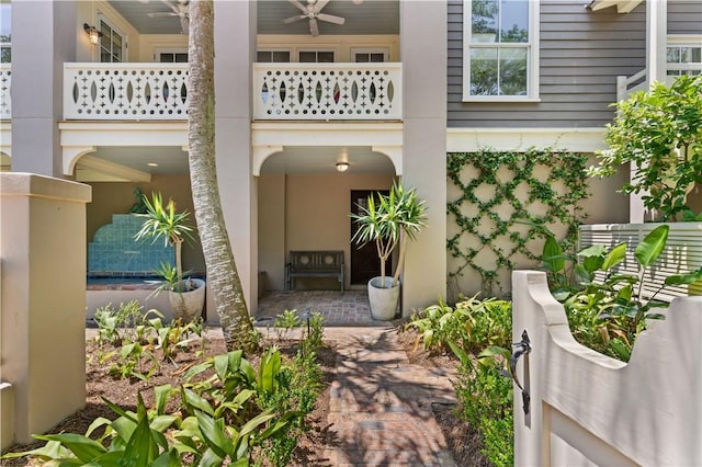 view of patio featuring a ceiling fan and a balcony