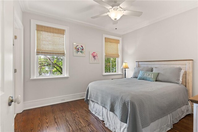 bedroom featuring baseboards, ceiling fan, ornamental molding, and wood finished floors